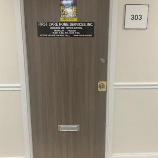 Office door with signage indicating business services, marked as room 303.