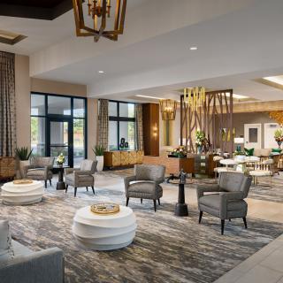 A spacious and elegantly designed hotel lobby with comfortable seating and modern decor.