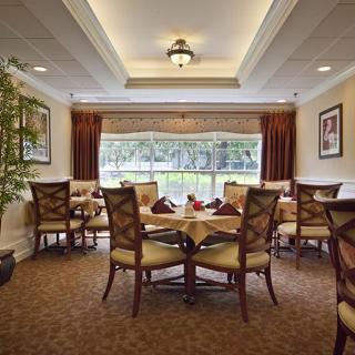 Elegant dining area with beautifully set tables and large windows.
