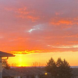 A stunning sunset paints the sky with vibrant hues of orange and purple, creating a serene evening atmosphere.