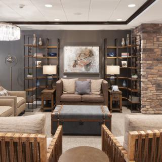 A stylish and modern living room with comfortable seating, decorative shelves, and elegant lighting.