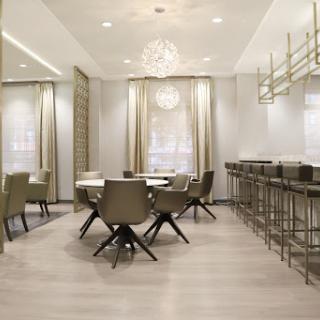 A stylish modern dining area featuring elegant furniture and soft lighting.