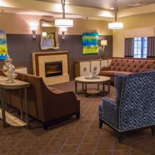 A modern lobby with comfortable seating and a cozy fireplace.
