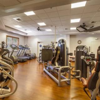 A well-equipped gym with various exercise machines and equipment.