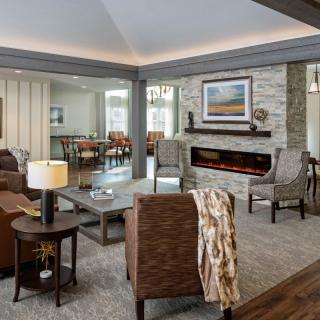 A modern living room featuring a cozy seating area with a fireplace and contemporary furniture.