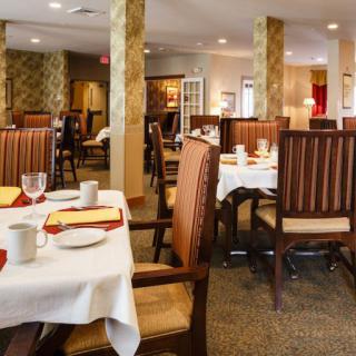 Cozy restaurant dining area with neatly set tables and chairs.
