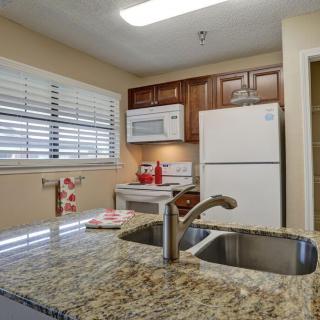Modern kitchen with granite countertops and standard appliances.