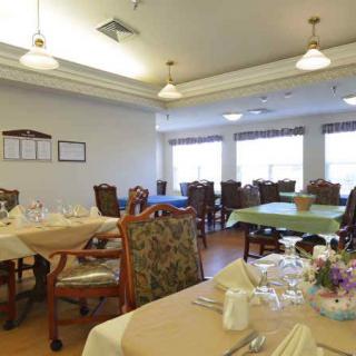 A cozy dining room with neatly arranged tables and elegant decor.