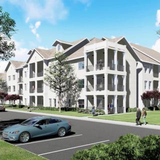 A modern apartment building with a spacious parking lot and landscaped surroundings.