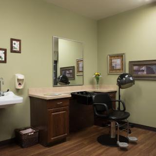 A serene hair salon setup with a mirror, styling chair, and subtle decor.