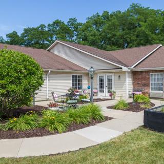 A charming suburban house with a well-maintained garden and outdoor seating area.