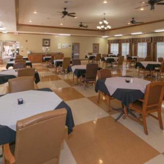 An empty dining area with neatly arranged tables and chairs.