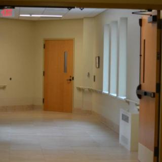 An empty hallway with doors and windows in a building.