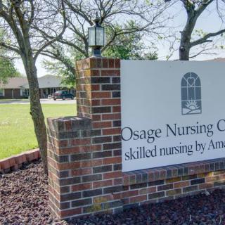 Entrance sign for Osage Nursing Center surrounded by trees and landscaping.