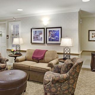 A cozy living room featuring a sofa, two armchairs, and stylish decor.