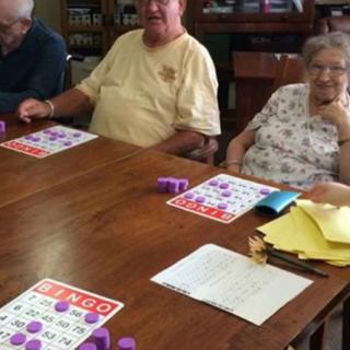 A group of elderly individuals enjoying a game of bingo together.