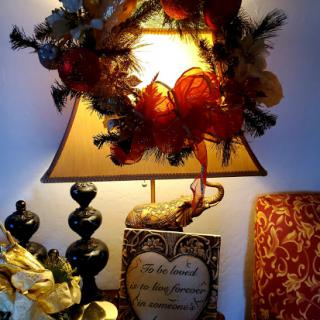 A beautifully decorated lamp adorned with a festive wreath, adding warmth and charm to the room.