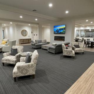 A modern living room with comfortable seating and a large television.