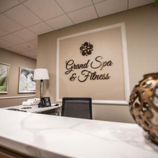 Reception area of the Grand Spa & Fitness center featuring elegant decor.