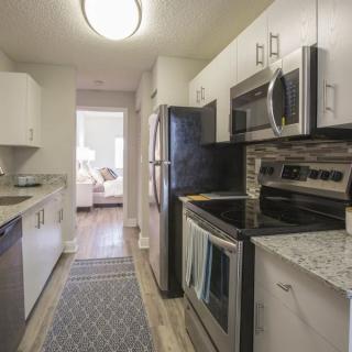 A modern kitchen with stainless steel appliances and light-colored cabinetry.