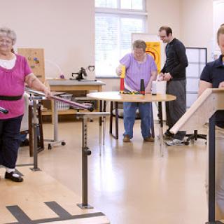 Elderly individuals participating in a physical therapy session to enhance mobility and strength.