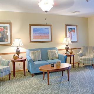 A cozy living room with comfortable seating and decorative artwork.
