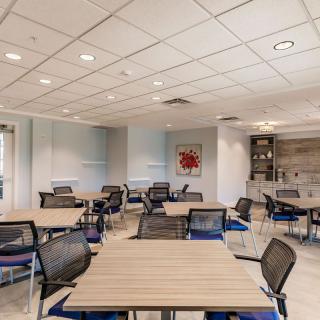 A modern conference room with several tables and chairs arranged for meetings.