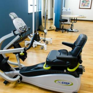 A fitness center equipped with a stationary bike and other exercise machines.