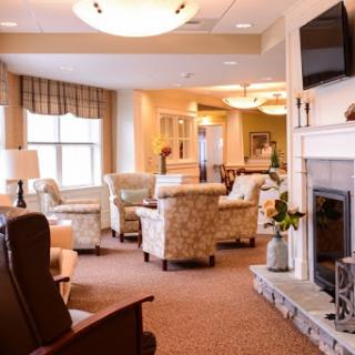 A cozy and inviting lounge area featuring comfortable seating and a warm fireplace.
