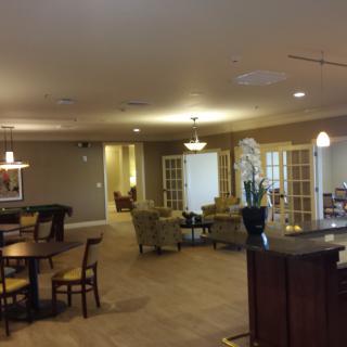 A spacious living area with seating and warm lighting.