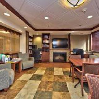An inviting office space with a conference area, featuring comfortable seating and modern decor.