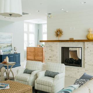 A cozy living room with modern decor and a fireplace.