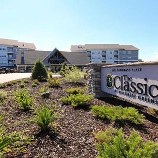 Entrance to a retirement community with landscaped grounds.