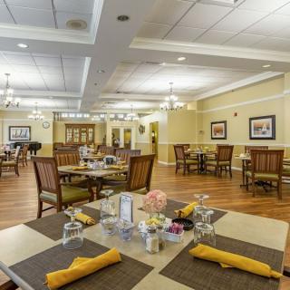 An elegant dining room with neatly set tables and comfortable seating.