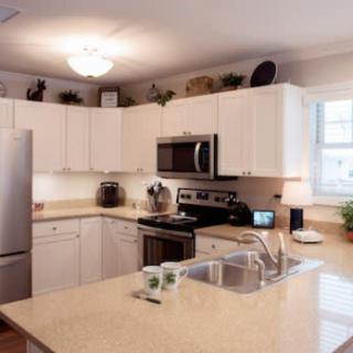 A modern kitchen featuring stainless steel appliances and a spacious countertop island.