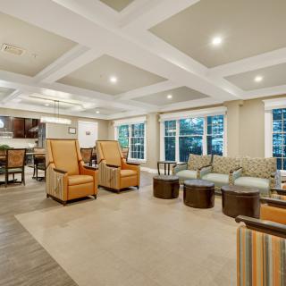 A spacious and modern living room with comfortable seating and elegant lighting.