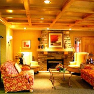 A warm and inviting living room featuring floral patterned chairs, a cozy fireplace, and ambient lighting.