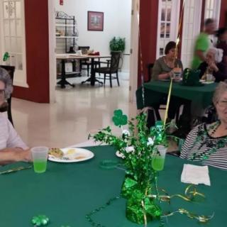 People enjoying a St. Patrick's Day celebration with green decorations and drinks.