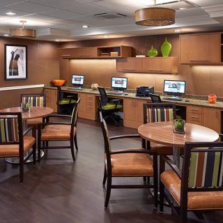 A modern office workspace featuring multiple computer stations and stylish seating arrangements.