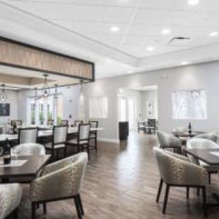 A modern restaurant dining area with tables and chairs arranged neatly.