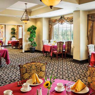 Elegant restaurant dining room with beautifully set tables and classic decor.
