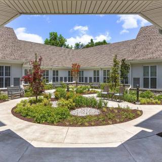 A beautifully landscaped courtyard surrounded by a building with modern architecture.