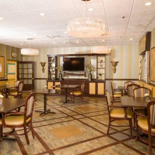 A cozy dining area with elegant furniture and warm lighting.