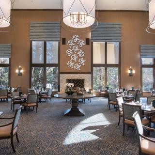 An elegant dining room with modern decor and ample natural light.