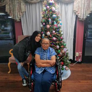 A joyful holiday moment in front of a beautifully decorated Christmas tree.
