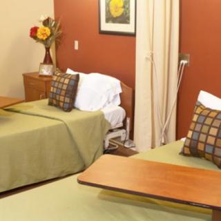 A hospital room with two beds and decorative elements.