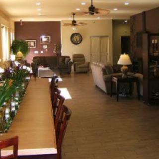 A spacious living room with comfortable seating, stylish furniture, and warm lighting.