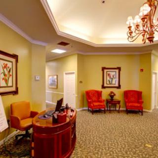 A warmly decorated lobby or reception area with comfortable seating and elegant lighting.