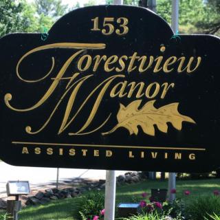 A sign for Forestview Manor Assisted Living located outdoors.