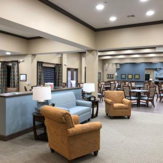 A spacious and well-lit lounge area with comfortable seating and modern decor.